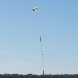 a man is flying a kite in a field 