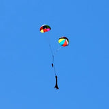 a man is flying a kite in a blue sky 