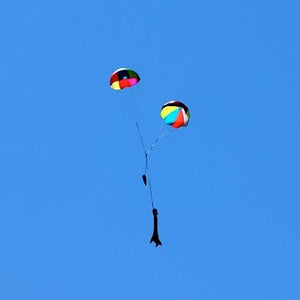 a man is flying a kite in a blue sky 
