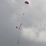 a group of kites flying in a cloudy sky 